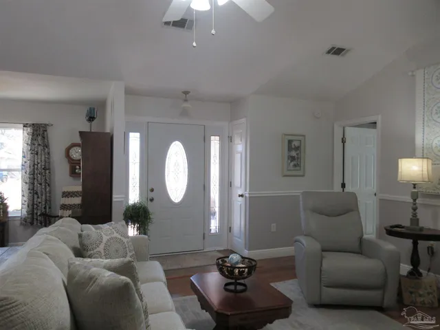 a living room with furniture and a mirror