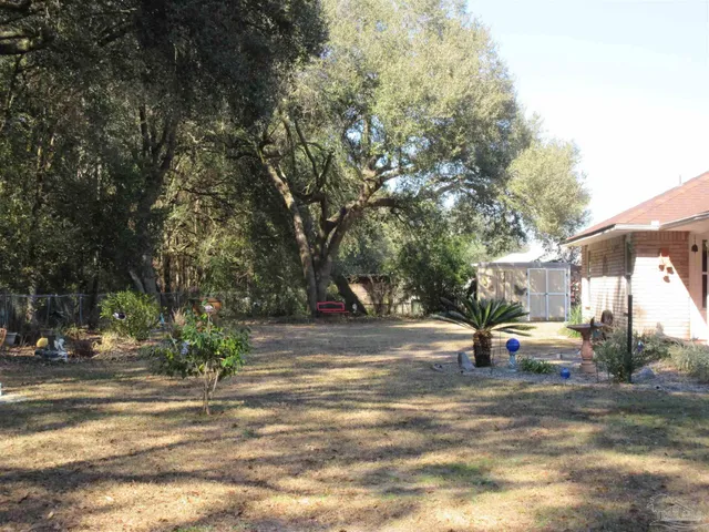 a front view of a house with a yard and potted plants