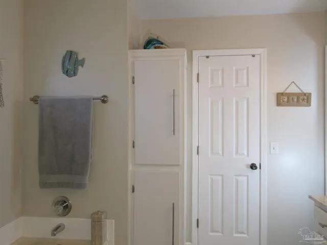 a sign board with buildings in the background