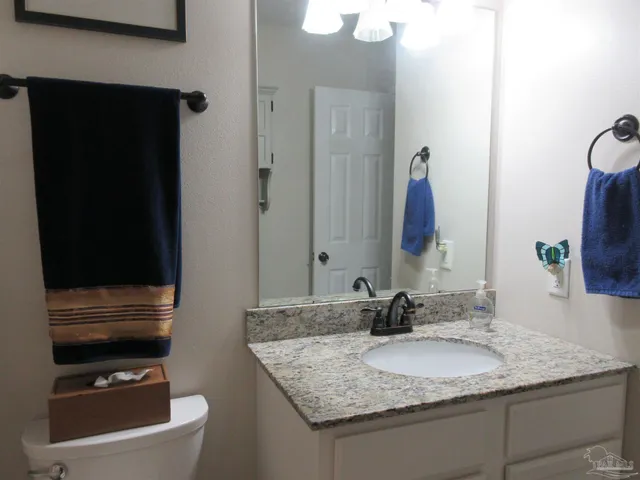 a wooden fence covered with tall trees