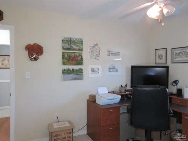 a front view of a house with a yard and potted plants