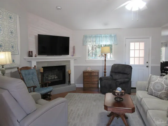 a living room with furniture a fireplace and a flat screen tv