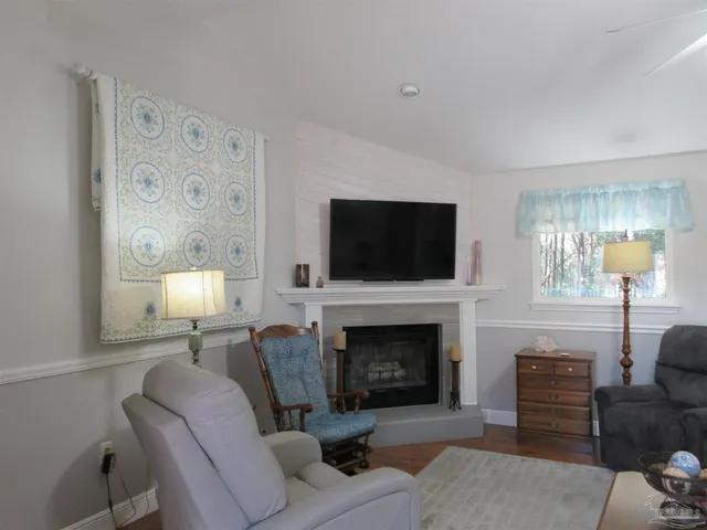 a living room with furniture fireplace and a flat screen tv
