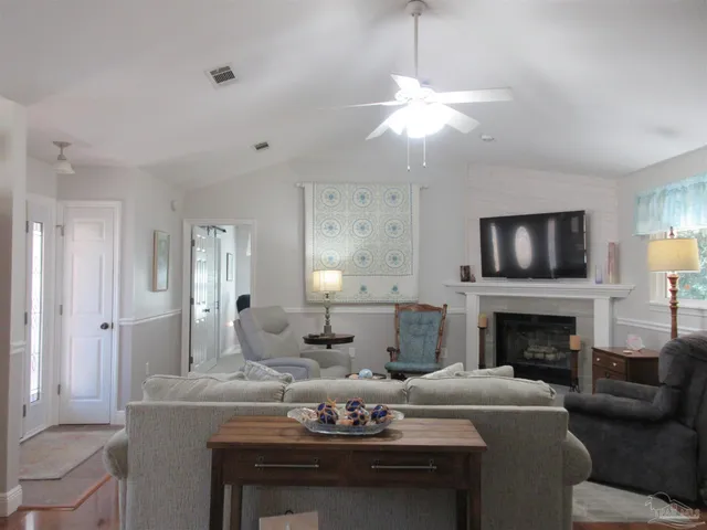 a living room with furniture and a large mirror