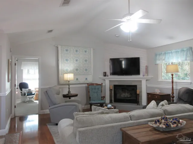 a living room with furniture and a large mirror
