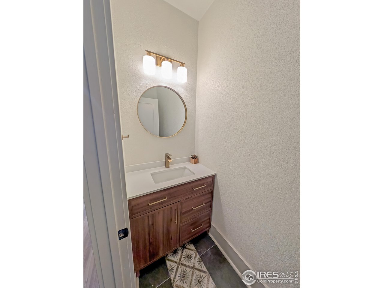 710 Carson Street Brush, CO 80723 - Photo 19 of 31 a bathroom with a sink and a mirror