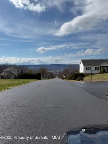 a view of building with car parked