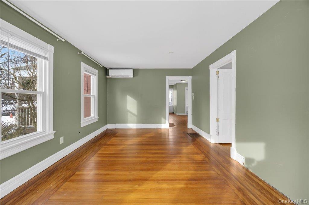 792 Springtown Road Rosendale, NY 12486 - Photo 25 of 45 Unfurnished room with hardwood / wood-style floors, plenty of natural light, and a wall unit AC