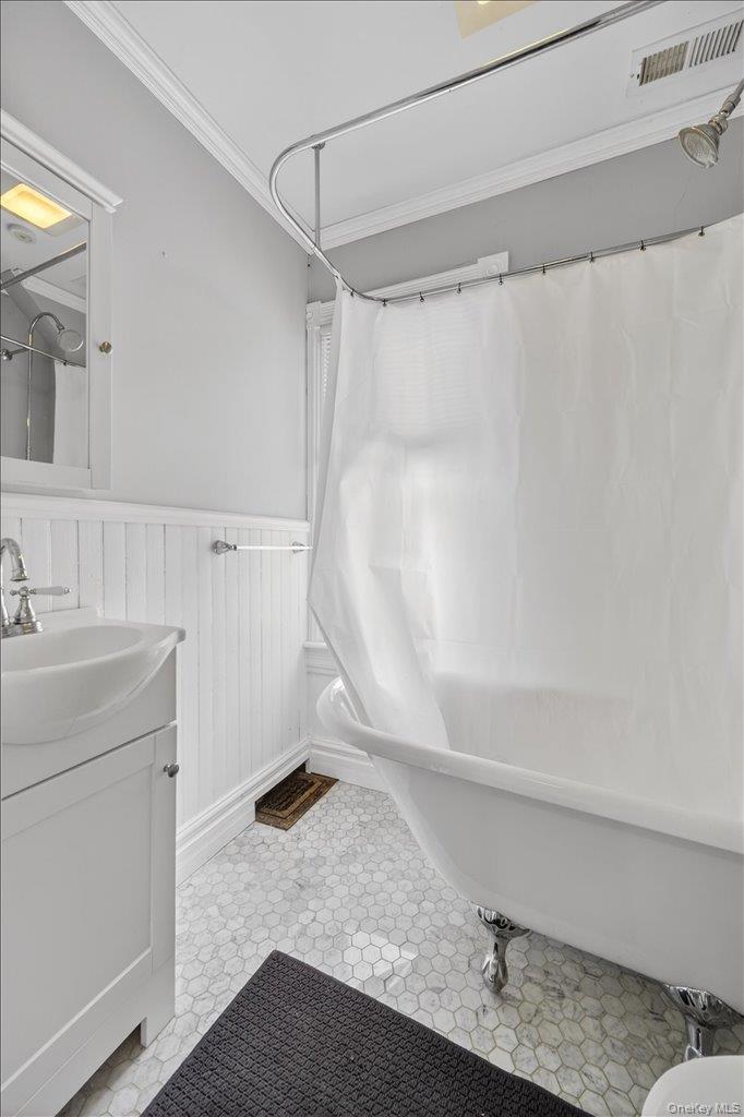 792 Springtown Road Rosendale, NY 12486 - Photo 36 of 45 Bathroom featuring wainscoting, vanity, ornamental molding, and shower / bath combo