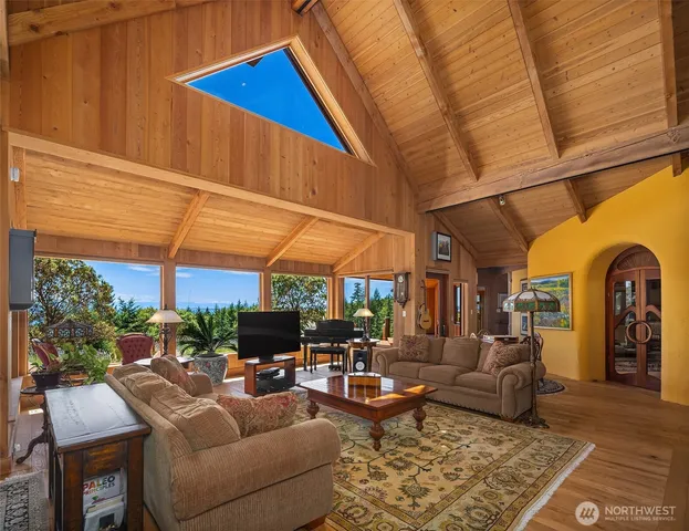 a living room with furniture a fireplace and a window