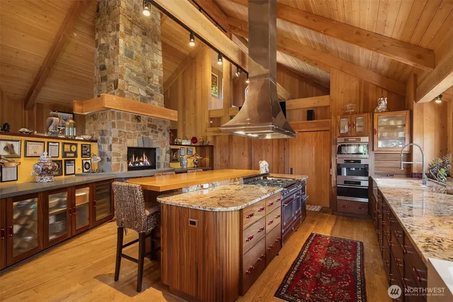 a kitchen with stainless steel appliances granite countertop a stove and a table