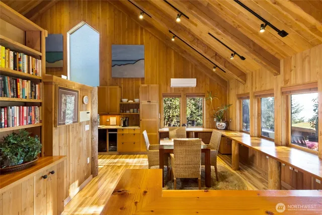 a very nice looking dining room with a large window and kitchen view