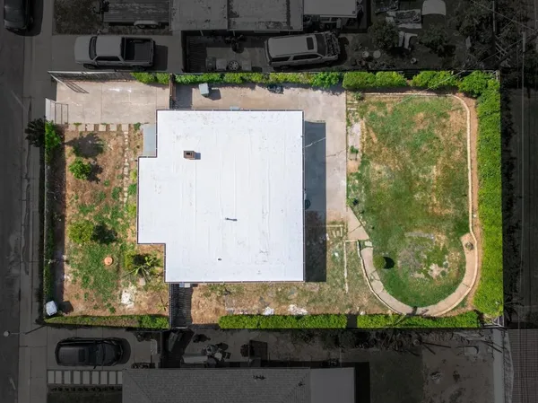 an aerial view of a house with a yard and a fountain