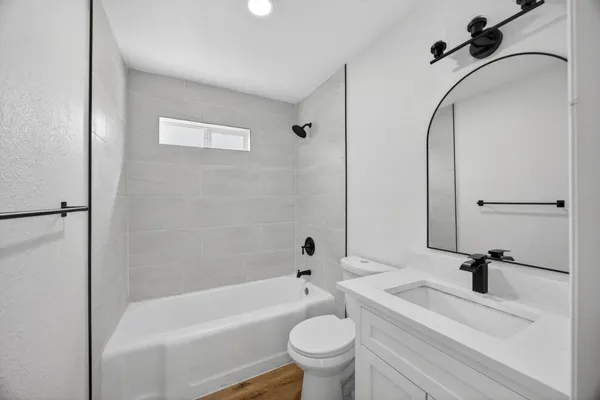 a bathroom with a sink a toilet and a bathtub