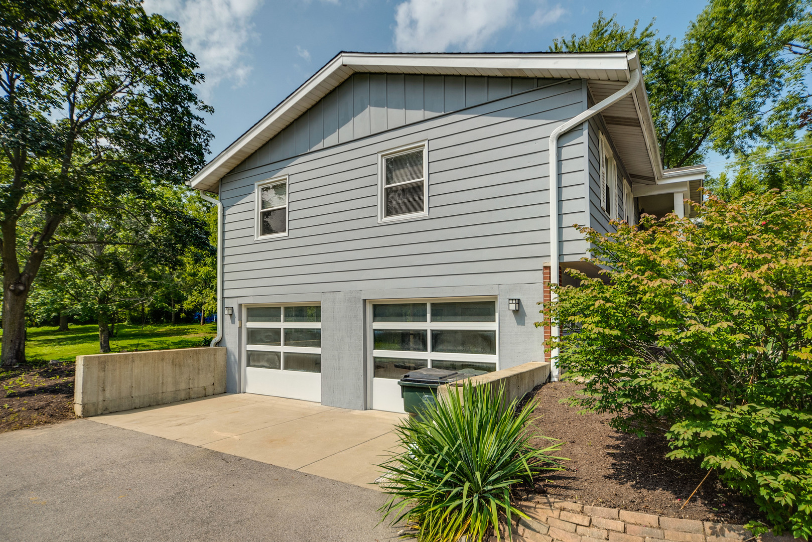 110 Haman Road Inverness, IL 60010 - Photo 30 of 30 a house with a large window and potted plants in front of door