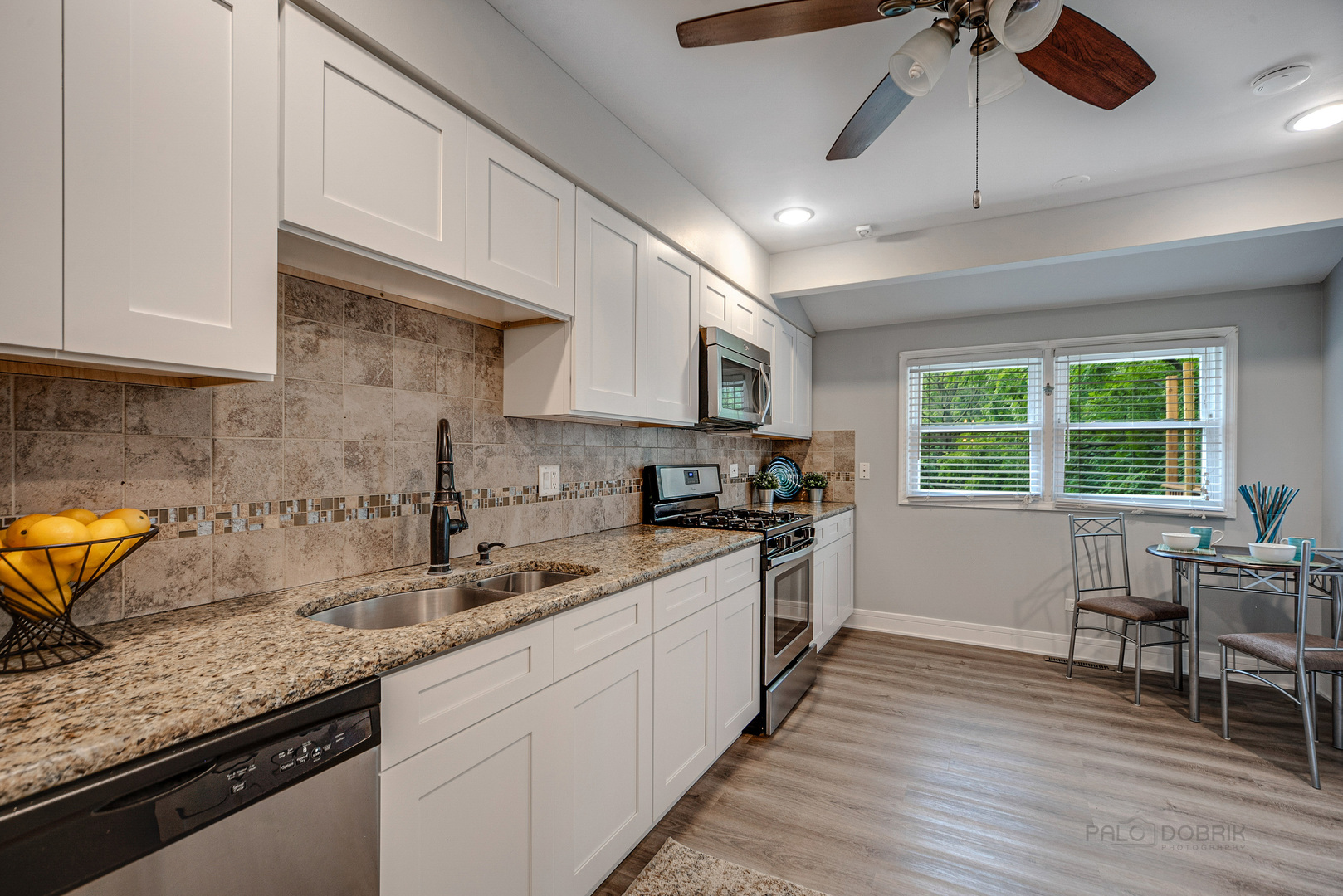 110 Haman Road Inverness, IL 60010 - Photo 9 of 30 a kitchen with stainless steel appliances granite countertop a sink a stove a refrigerator cabinets and wooden floor