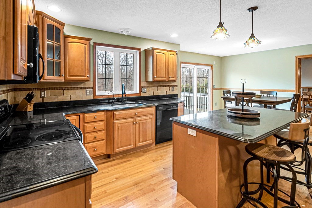 34 Schneider Road Somers, CT 06071 - Photo 12 of 42 a kitchen with stainless steel appliances granite countertop a stove a sink dishwasher and cabinets with wooden floor