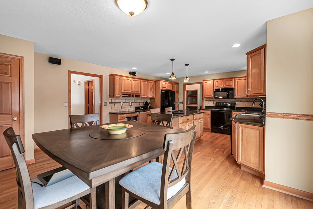 34 Schneider Road Somers, CT 06071 - Photo 13 of 42 a kitchen with stainless steel appliances granite countertop a stove a refrigerator a kitchen island a table and chairs