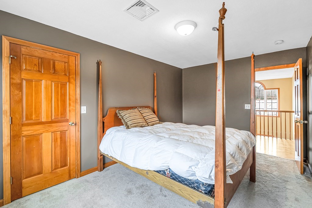 34 Schneider Road Somers, CT 06071 - Photo 29 of 42 a bedroom with a bed and wooden floor