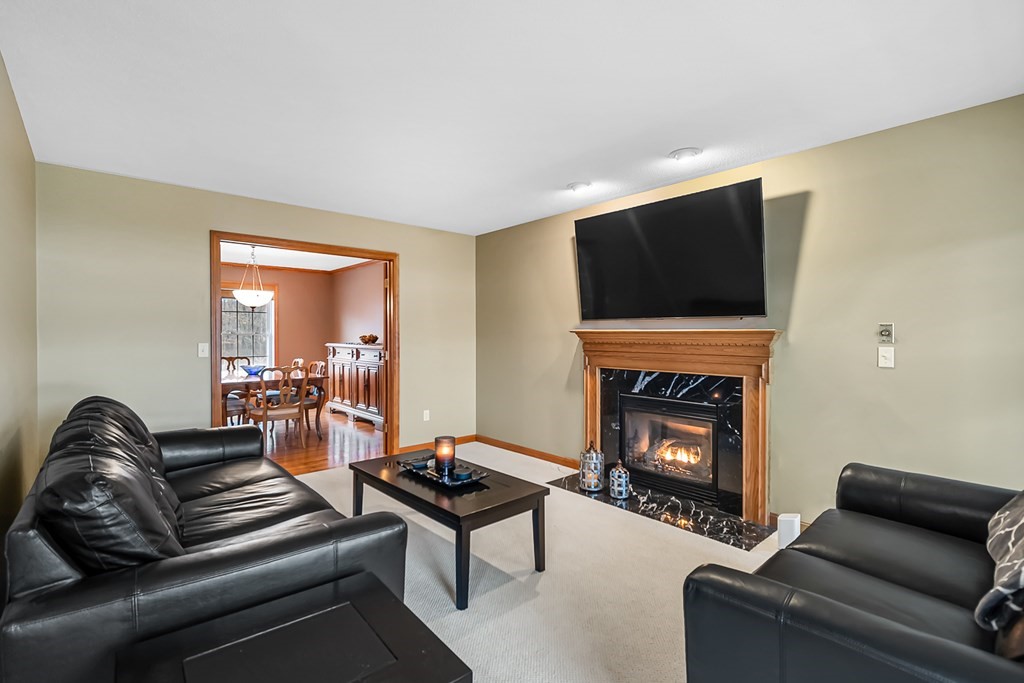 34 Schneider Road Somers, CT 06071 - Photo 5 of 42 a living room with furniture a fireplace and a flat screen tv