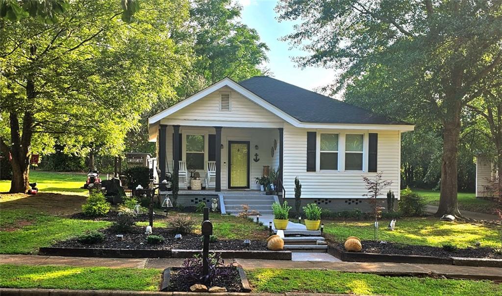 a front view of a house with garden