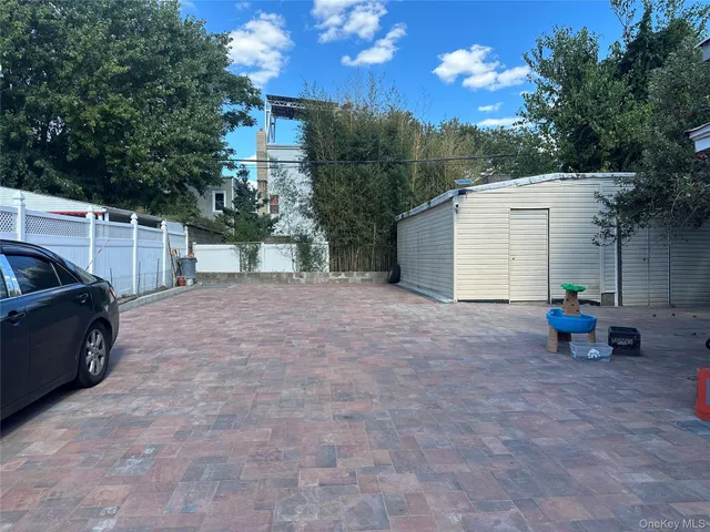 a view of a backyard with furniture and a fire pit