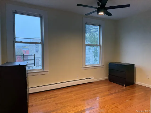 an empty room with windows and closet