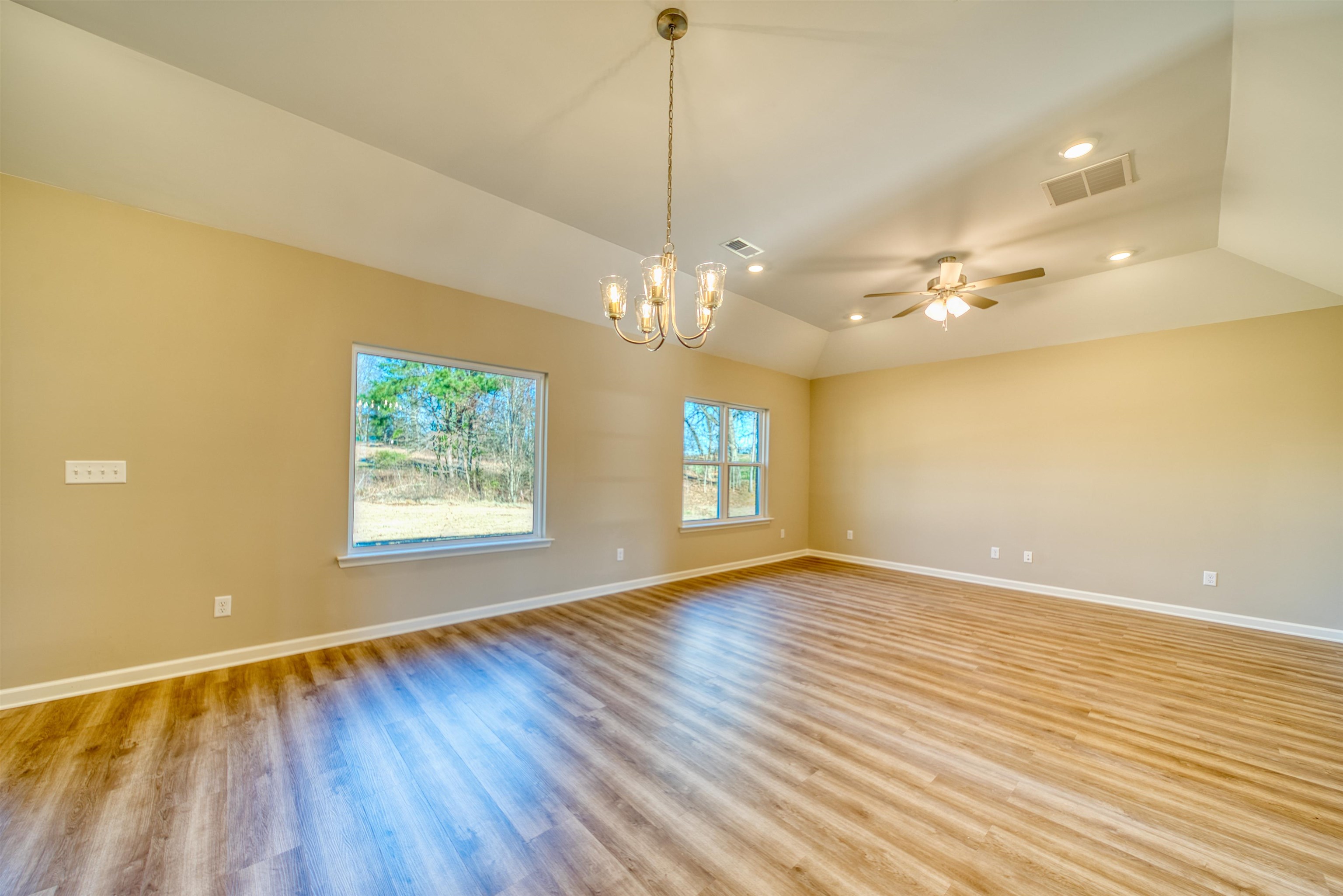 102 Stone Brook Cove Ripley, TN 38063 - Photo 30 of 32 Unfurnished room with a chandelier, light wood finished floors, vaulted ceiling, a ceiling fan, and recessed lighting