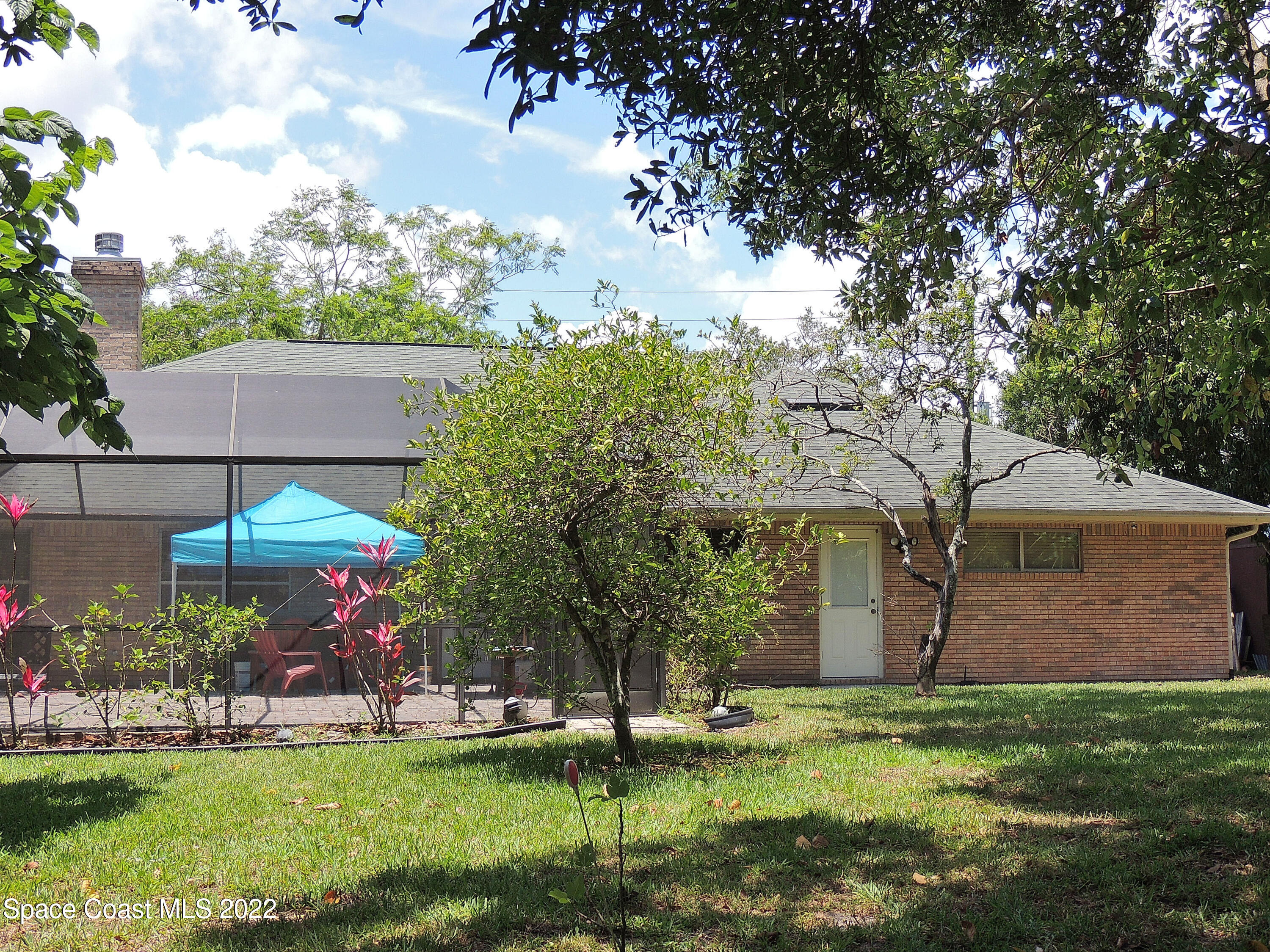 2473 Harlock Road Melbourne, FL 32934 - Photo 33 of 45 a view of a house with a yard and sitting area