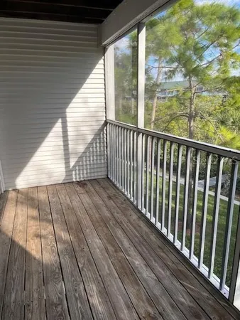 a view of balcony with wooden floor