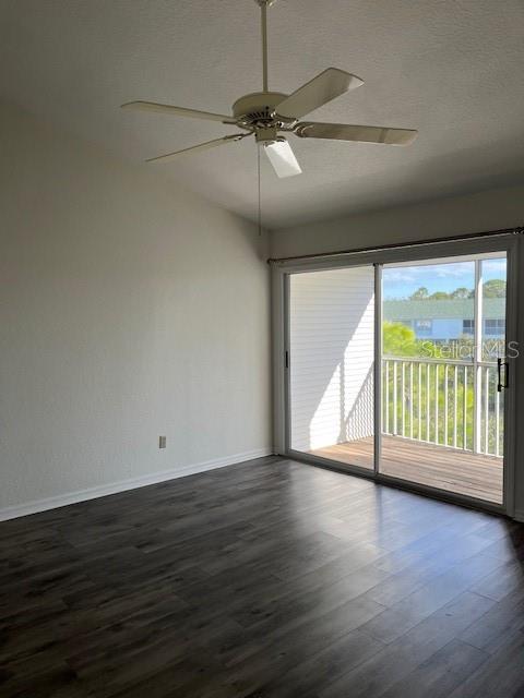 14839 Seminole Trail Seminole, FL 33776 - Photo 23 of 35 an empty room with wooden floor fan and windows