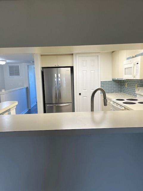 14839 Seminole Trail Seminole, FL 33776 - Photo 28 of 35 a view of a sink a refrigerator and wooden floor