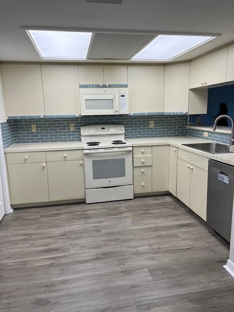 14839 Seminole Trail Seminole, FL 33776 - Photo 4 of 35 a kitchen with granite countertop stainless steel appliances cabinets a sink and a wooden floor