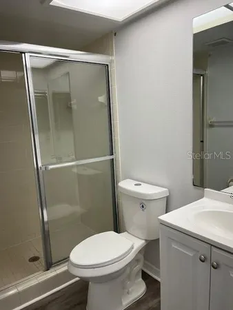 a bathroom with a toilet and a shower