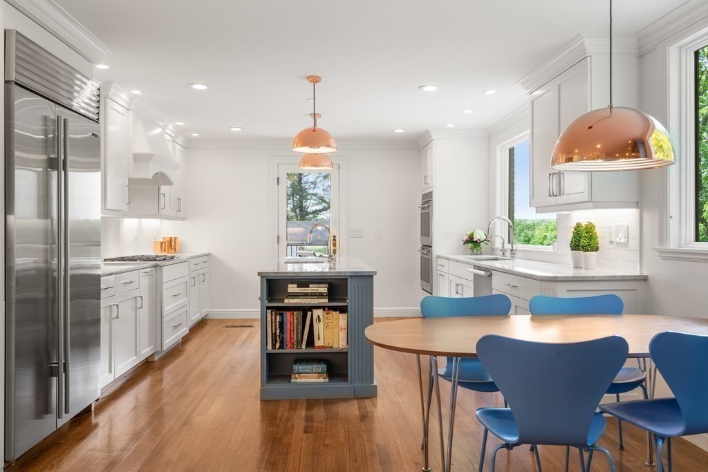 32 Maugus Avenue Wellesley, MA 02481 - Photo 12 of 42 a kitchen with a table chairs refrigerator and cabinets