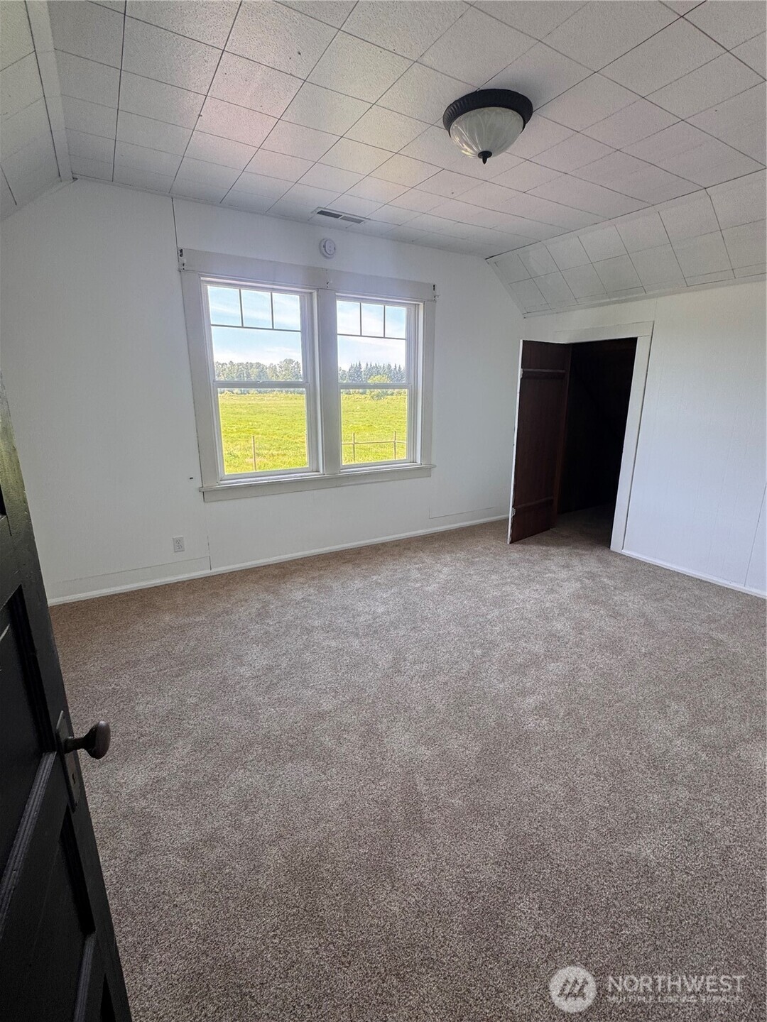 20016 Orville Road East Orting, WA 98360 - Photo 17 of 18 a view of an empty room with a window and a kitchen