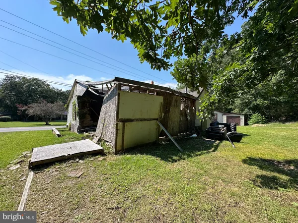 a view of a backyard with a table and chairs under an umbrella