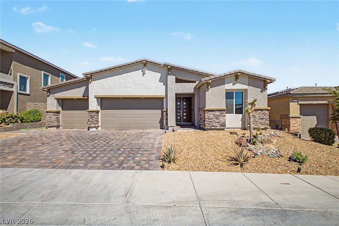 226 Augusta Ridge Henderson, NV 89015 - Photo 3 of 47 This modern desert home showcases a blend of stucco and stone with an attached garage.