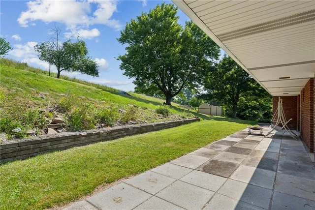 a aerial view of a house with a big yard and large trees