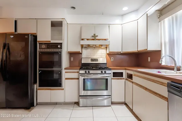 a view of a dining room and livingroom with furniture wooden floor and a clock