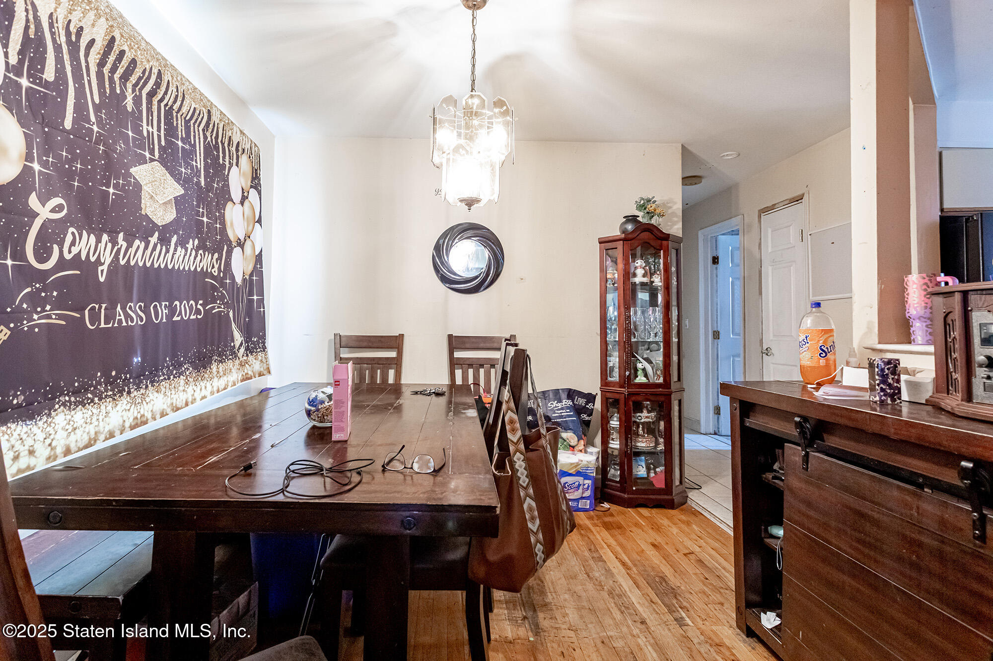 27 Bascom Place Staten Island, NY 10314 - Photo 14 of 25 a view of a dining room and livingroom with furniture wooden floor and a clock