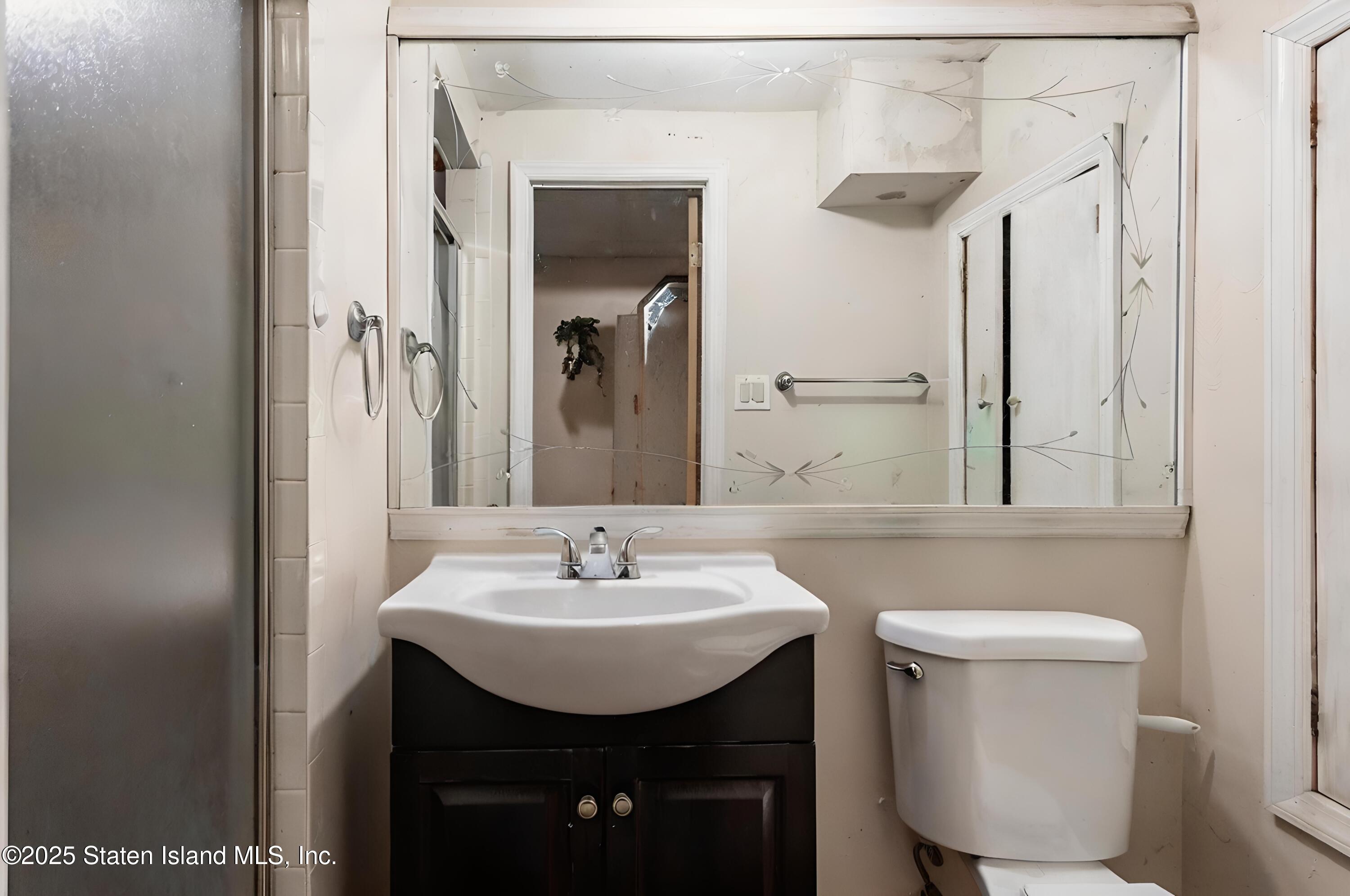 27 Bascom Place Staten Island, NY 10314 - Photo 15 of 25 a bathroom with a sink a toilet and shower