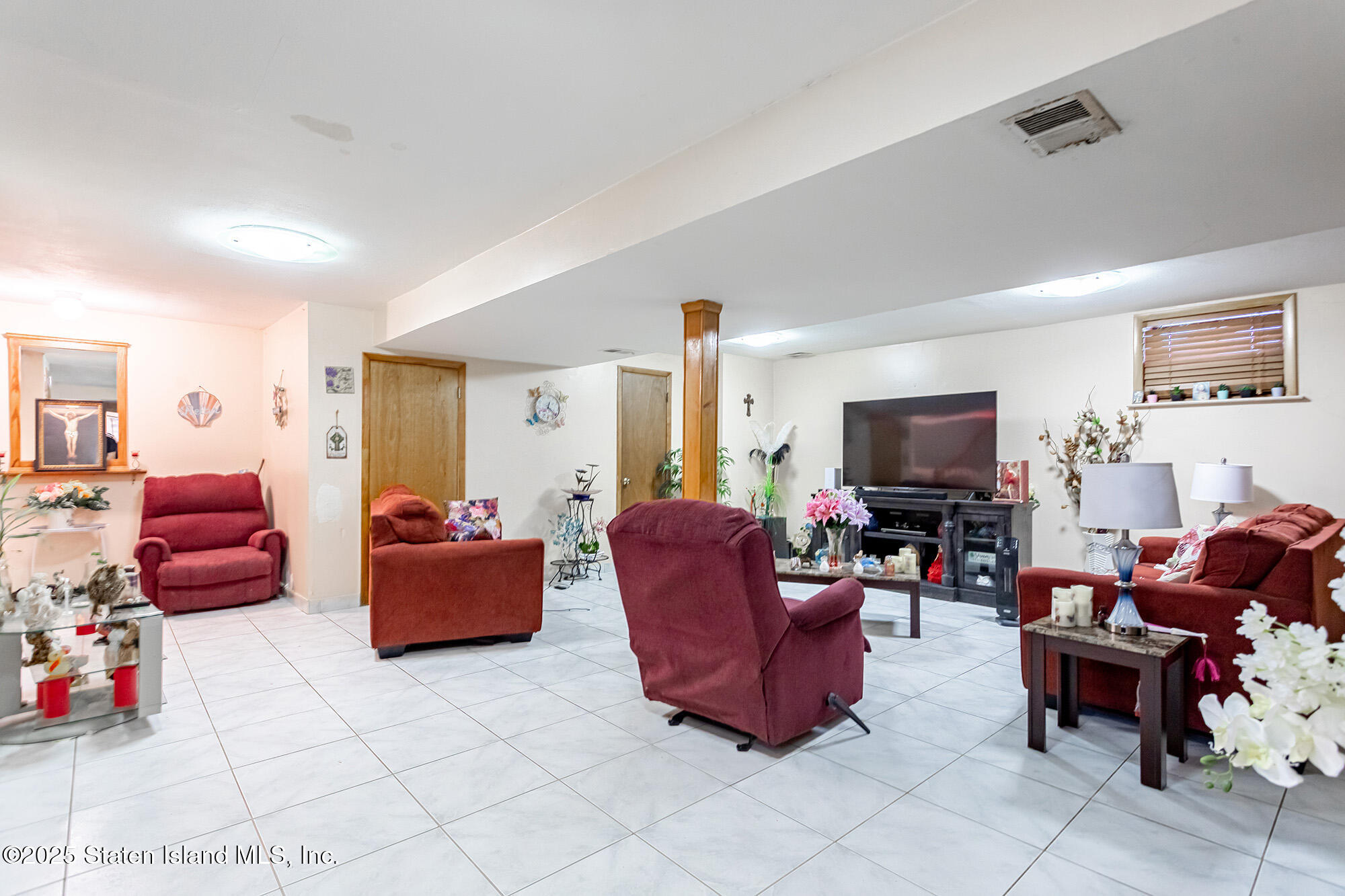 27 Bascom Place Staten Island, NY 10314 - Photo 18 of 25 a living room with furniture and a flat screen tv