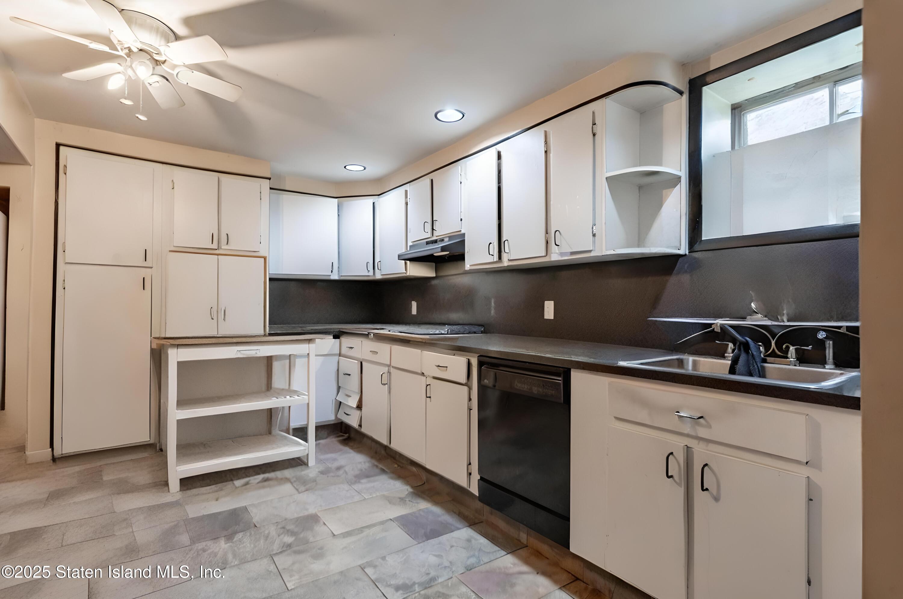 27 Bascom Place Staten Island, NY 10314 - Photo 19 of 25 a kitchen with granite countertop a sink stainless steel appliances and cabinets