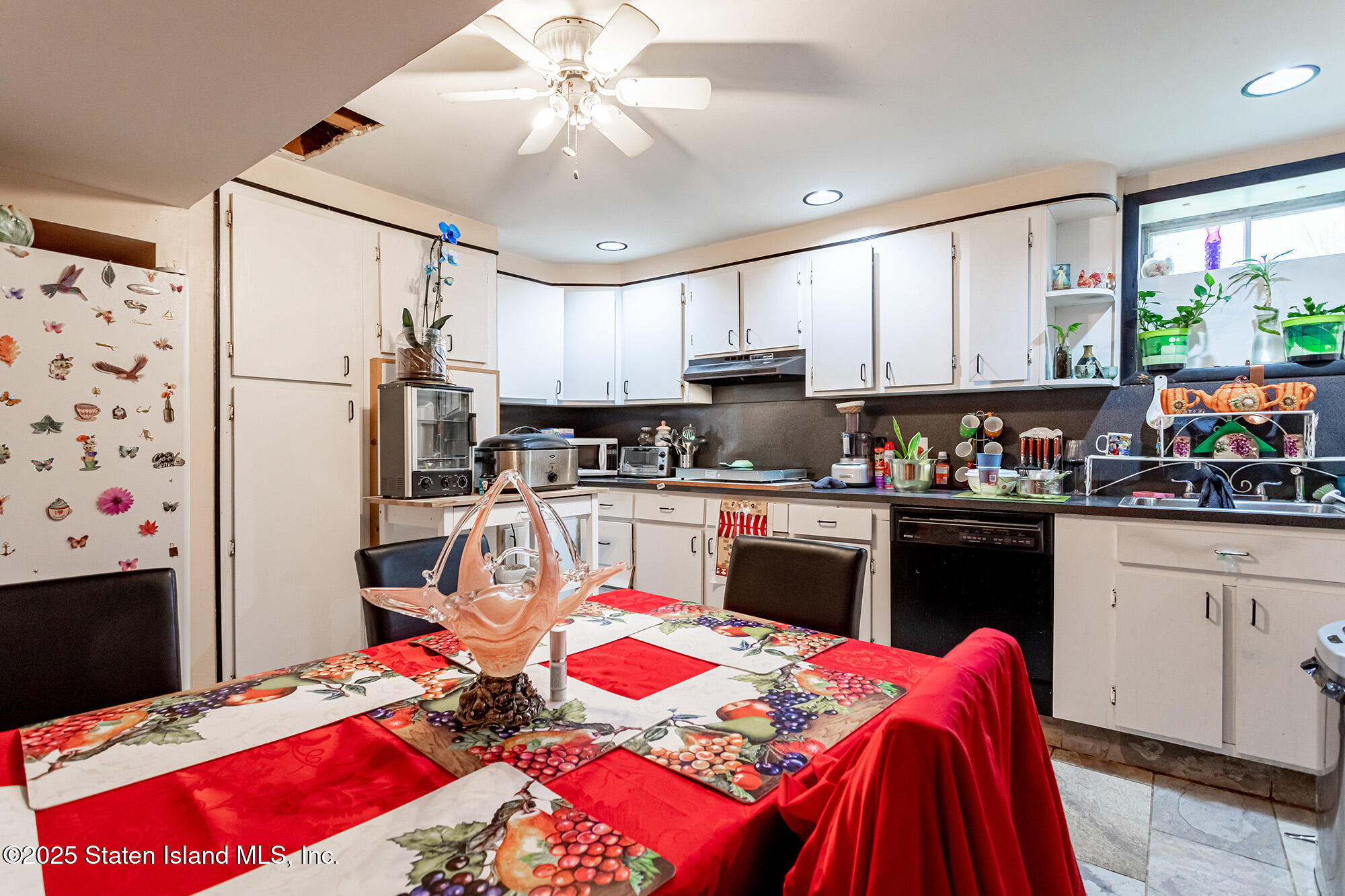 27 Bascom Place Staten Island, NY 10314 - Photo 20 of 25 a kitchen with stainless steel appliances kitchen island granite countertop a refrigerator a sink dishwasher and a flat tv screen