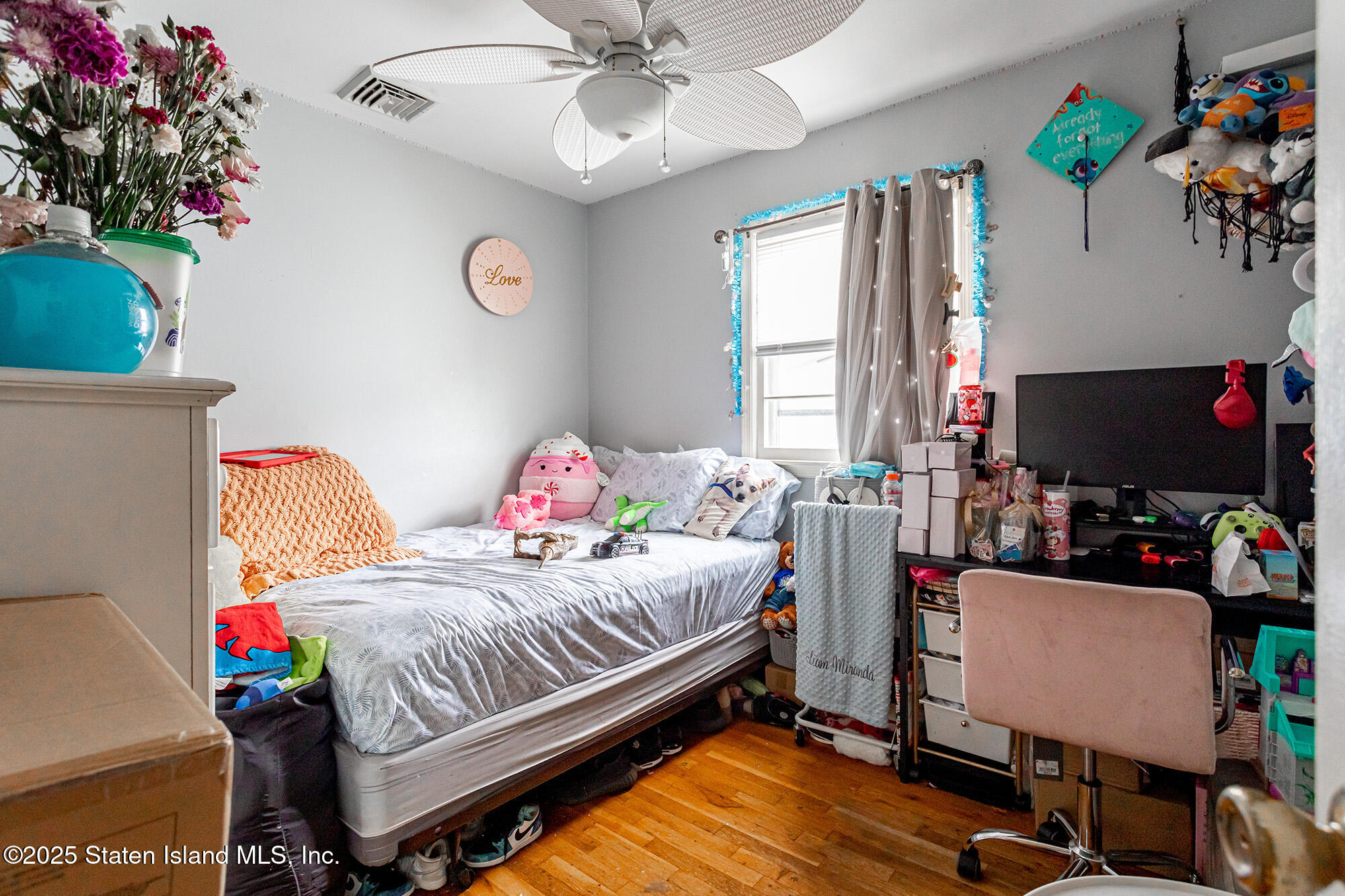 27 Bascom Place Staten Island, NY 10314 - Photo 10 of 25 a bedroom with a bed and a chandelier