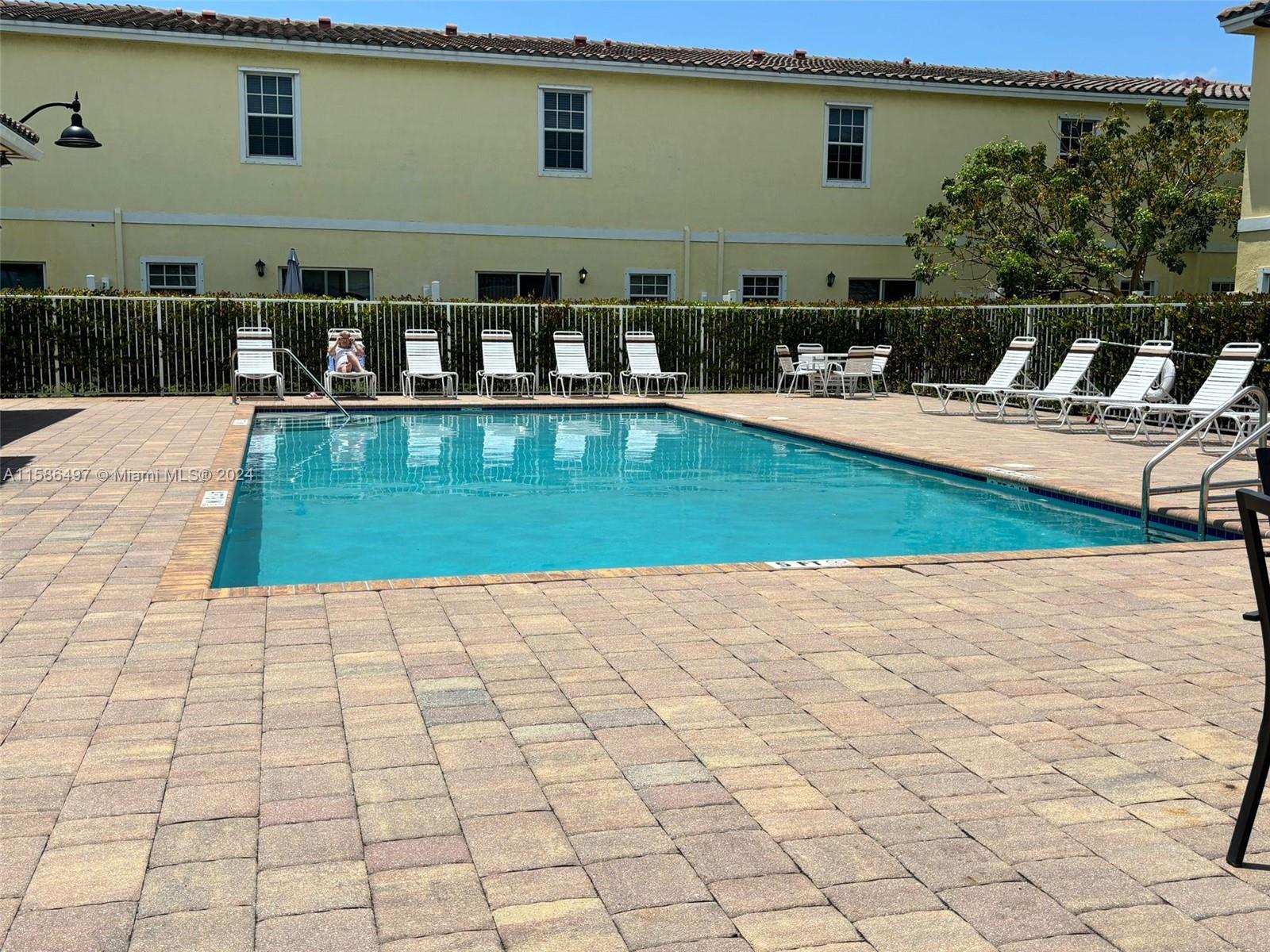 a view of swimming pool with outdoor seating