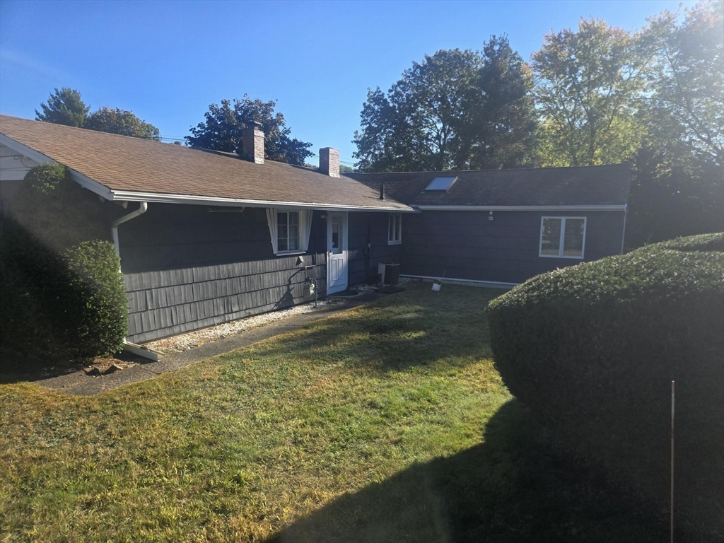 1 Ridgehill Road Canton, MA 02021 - Photo 28 of 39 a backyard of a house with yard and outdoor seating