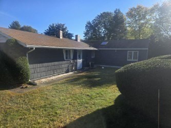 1 Ridgehill Road Canton, MA 02021 - Photo 34 of 39 a backyard of a house with yard and outdoor seating