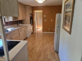 1 Ridgehill Road Canton, MA 02021 - Photo 10 of 39 a kitchen with granite countertop a sink stove and refrigerator
